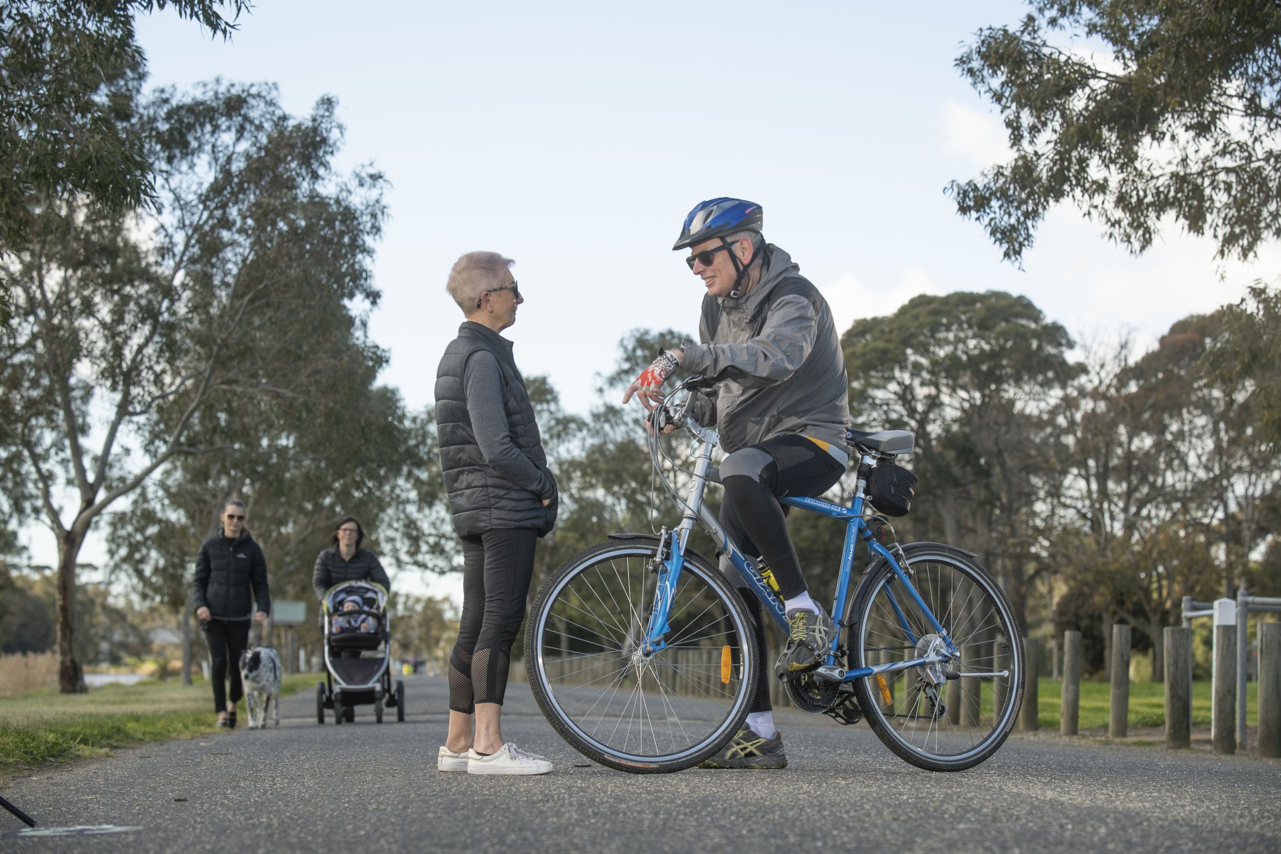 Older people meeting for a chat on a path